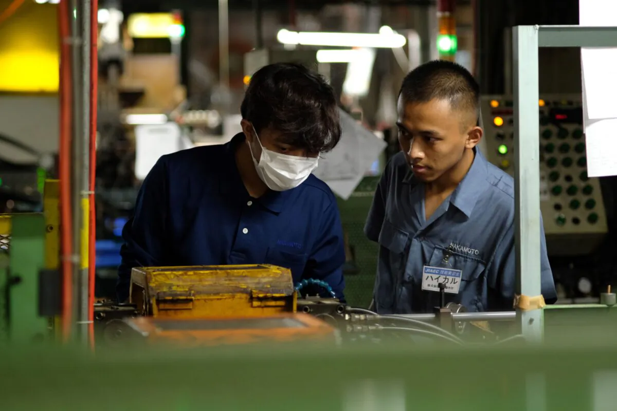Indonesian workers processing copper pipes at a Nakamoto manufacturing   factory in Oizumi, Gunma prefecture, Japan on Oct. 16, 2018. (Kazuhiro Nogi/ AFP via Getty Images)