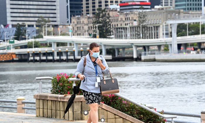 A lady is seen going for her morning walk wearing her mask at Southbank, Brisbane in Australia on Sept. 29, 2021. (Bradley Kanaris/Getty Images)