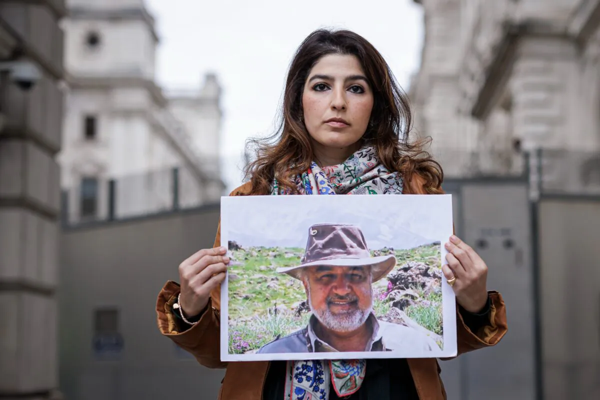 Roxanne Tahbaz holds a photograph of her father, Morad Tahbaz, outside the Foreign, Commonwealth and Development Office (FCDO) in London, on April 13, 2022. (Rob Pinney/Getty Images)