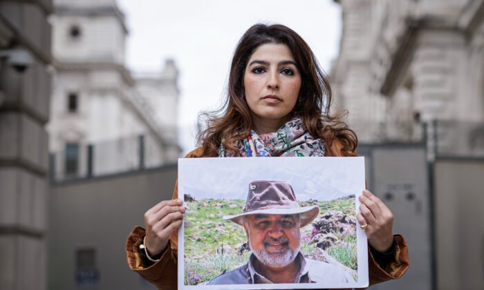 Roxanne Tahbaz holds a photograph of her father, Morad Tahbaz, outside the Foreign, Commonwealth and Development Office (FCDO) in London, on April 13, 2022. (Rob Pinney/Getty Images)