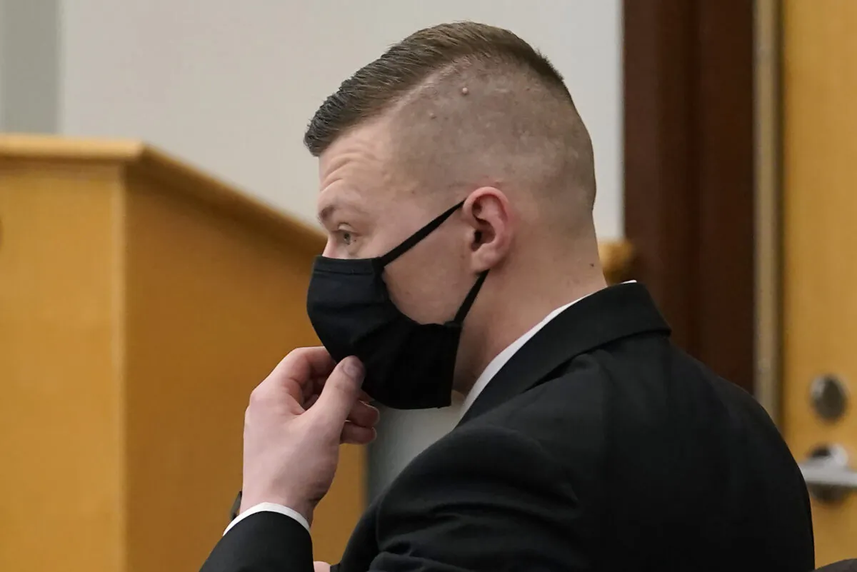 Volodymyr Zhukovskyy of West Springfield, Mass., charged with negligent homicide in the deaths of seven motorcycle club members in a 2019 crash, adjusts his mask at Coos County Superior Court in Lancaster, N.H., on July 26, 2022, before opening statements in his trial. (Steven Senne/Pool via AP)