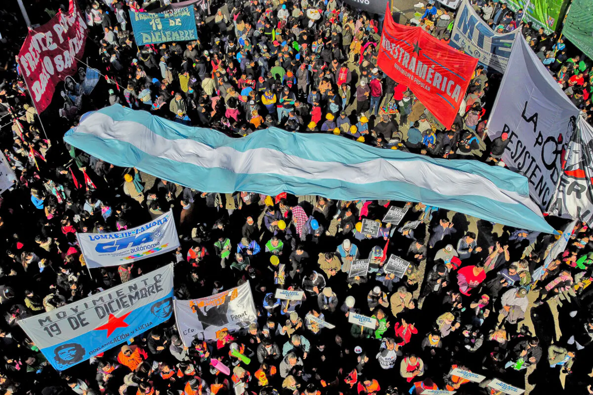 Members of social and trade union organizations protesting on July 20, 2022, in Buenos Aires, in demand of a universal basic income. The impoverished South American country struggles to repay its US$44 billion dollar debt with the International Monetary Fund (IMF) amid rampant inflation and social unrest. (Luis Robayo/AFP via Getty Images)