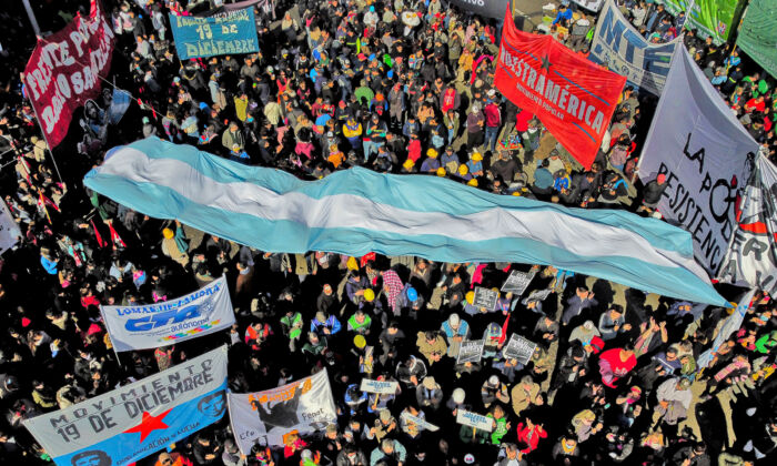 Members of social and trade union organizations protesting on July 20, 2022, in Buenos Aires, in demand of a universal basic income. The impoverished South American country struggles to repay its US$44 billion dollar debt with the International Monetary Fund (IMF) amid rampant inflation and social unrest. (Luis Robayo/AFP via Getty Images)