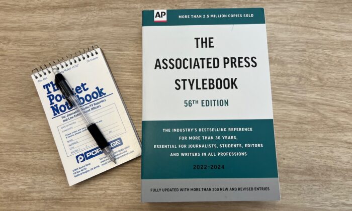 A copy of the Associated Press Stylebook and a reporter's pad in New York on July 27, 2022. (Epoch Times Staff)