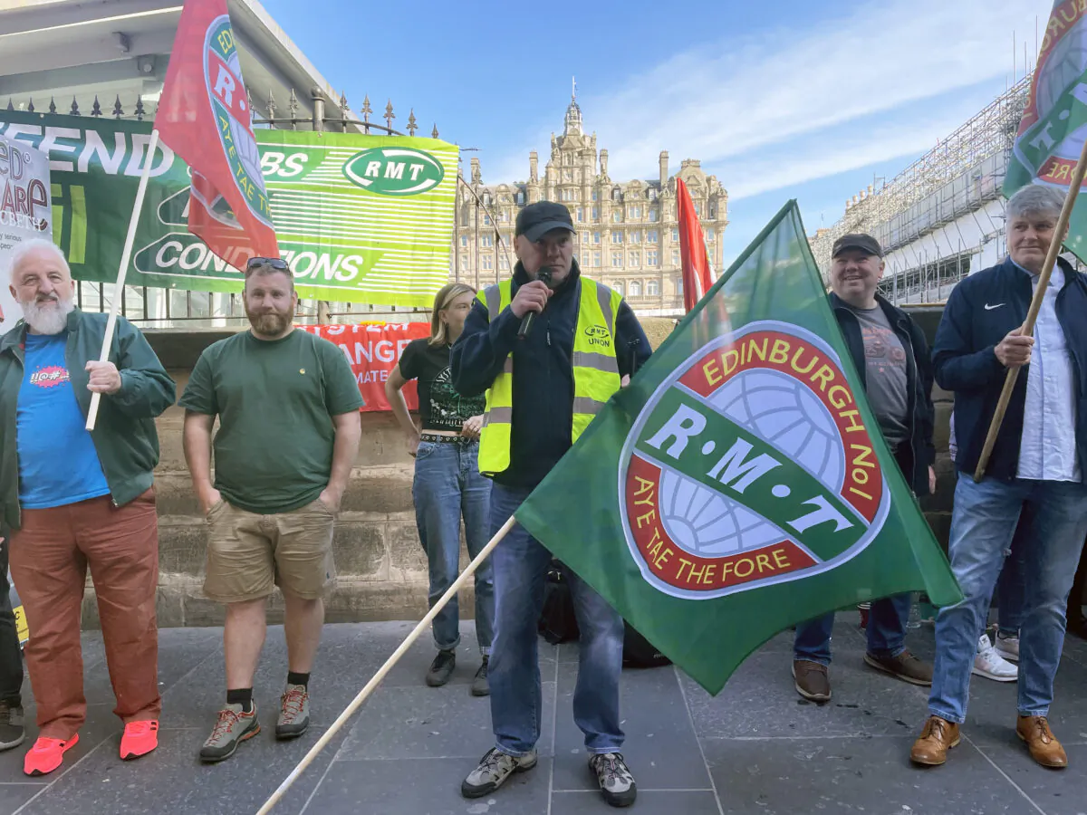 Members of the Rail, Maritime, and Transport union (RMT) on the picket line outside Edinburgh Waverley train station, in Edinburgh, Scotland, on July 27, 2022. (Katharine Hay/PA Media)