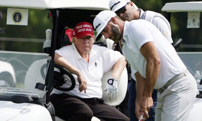 Former President Donald Trump sits in a golf cart as he watches Dustin Johnson putt during the pro-am round of the LIV Golf Invitational Bedminster at Trump National Golf Club Bedminster in N.J. on July 28, 2022. (Seth Wenig/AP Photo)