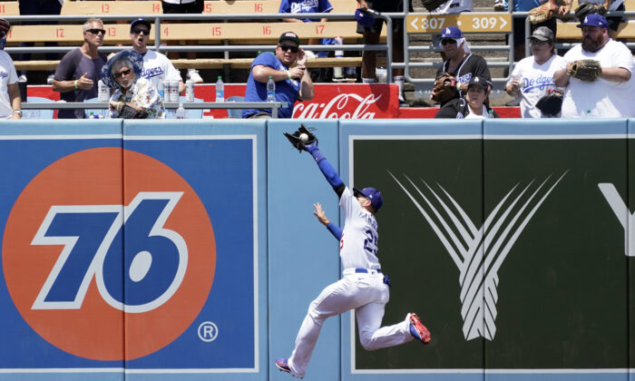 Los Angeles Dodgers center fielder Trayce Thompson makes a leaping catch on a line drive from Washington Nationals' Luis Garcia during the fifth inning of a baseball game at Dodger Stadium, in Los Angeles, on July 27, 2022. (Marcio Jose Sanchez/AP Photo)