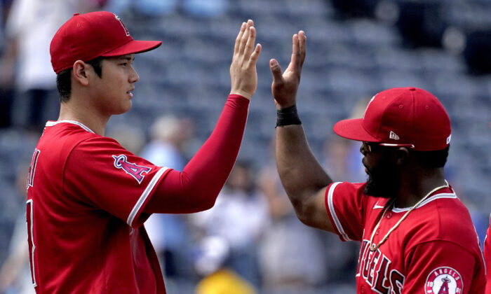 Los Angeles Angels' Shohei Ohtani, left, and Luis Rengifo celebrate after their baseball game against the Kansas City Royals, in Kansas City, Mo., on July 27, 2022.  (Charlie Riedel/AP Photo)