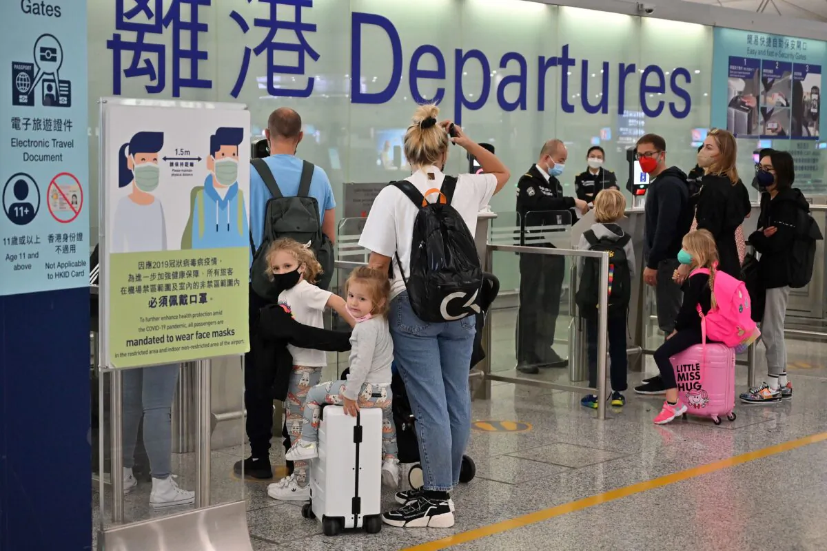 Expat families depart from Hong Kong's Chek Lap Kok international airport on March 6, 2022. Travel restrictions have hit Hong Kong's white collar foreign workers hard. (Peter Parks/AFP via Getty Images)