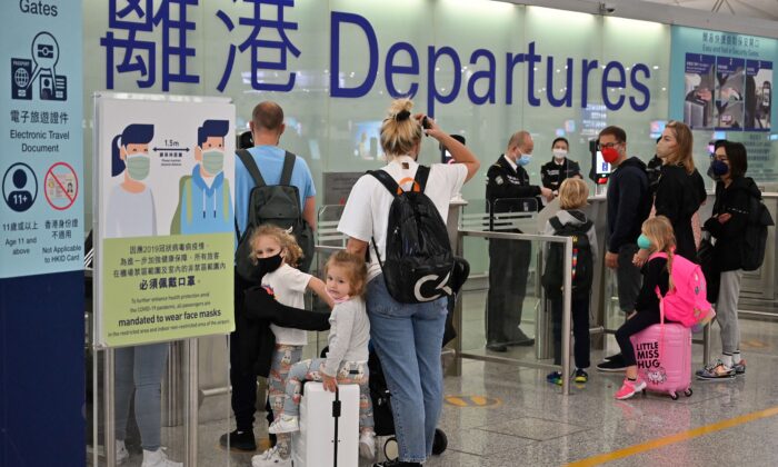 Expat families depart from Hong Kong's Chek Lap Kok international airport on March 6, 2022. Travel restrictions have hit Hong Kong's white collar foreign workers hard. (Peter Parks/AFP via Getty Images)
