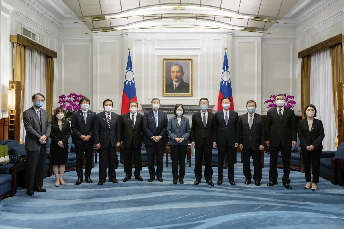 Taiwan's President Tsai Ing-wen (center) and Taiwanese officials pose for photos with a Japanese delegation at the Presidential office in Taipei, Taiwan on July 28, 2022. (Taiwan Presidential Office via AP)