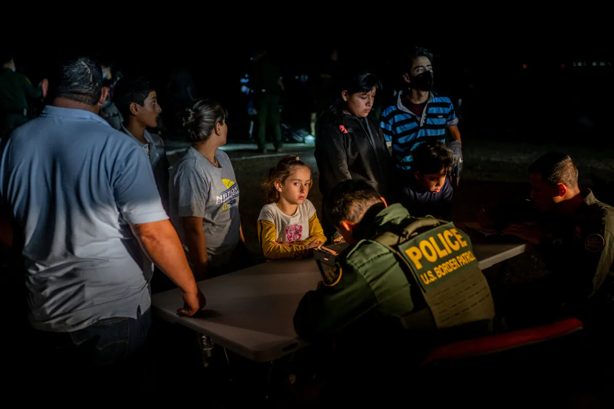 Border Patrol officers process a migrant family after they crossed the Rio Grande into the United States in Roma, Texas, on May 5, 2022. (Brandon Bell/Getty Images)
