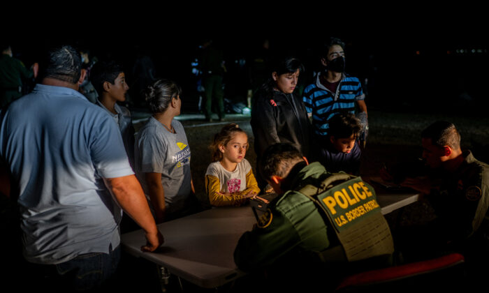 Border Patrol officers process a migrant family after they crossed the Rio Grande into the United States in Roma, Texas, on May 5, 2022. (Brandon Bell/Getty Images)