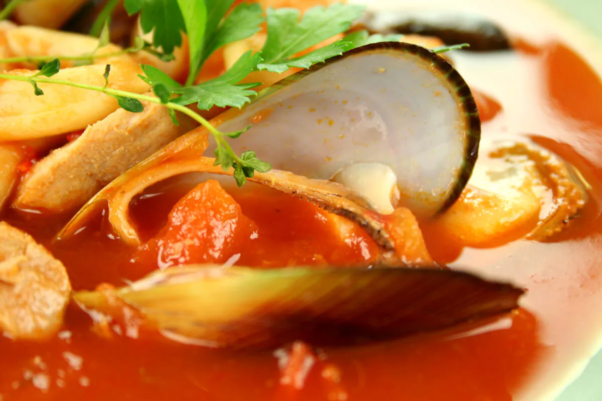 Mussels pair wonderfully with a tomato and white wine broth for an easy to prepare, adaptable meal. (jabiru/Shutterstock)