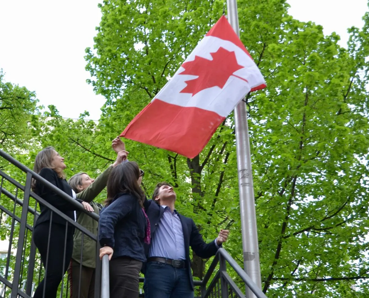 Deputy Prime Minister Chrystia Freeland, Foreign Affairs Minister Melanie Joly, Canada's ambassador to Ukraine Larisa Galadza and Prime Minister Justin Trudeau raise the flag over the Canadian embassy in Kyiv, Ukraine on May 8, 2022. (The Canadian Press/CBC News/Pool/Murray Brewster)