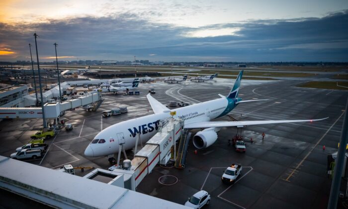 A WestJet Airlines Boeing 787-9 Dreamliner is seen parked at a gate at Vancouver International Airport, in Richmond, B.C., on Jan. 21, 2021. (The Canadian Press/Darryl Dyck)
