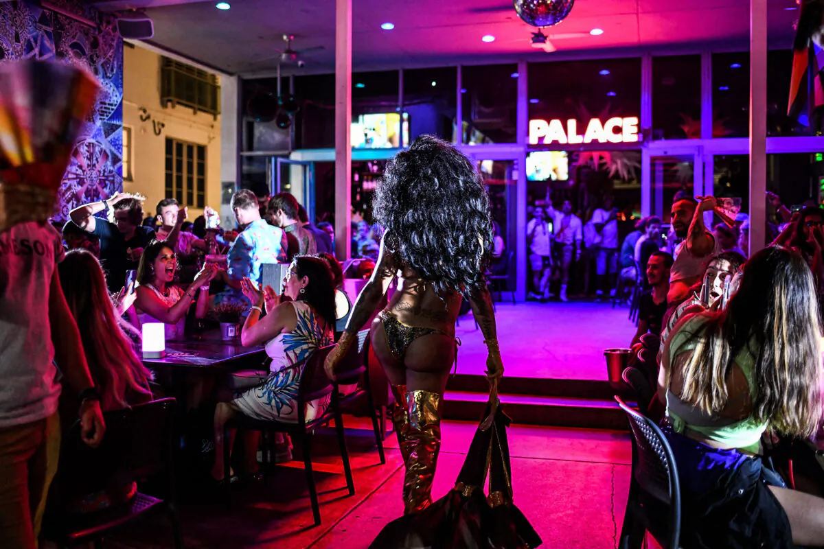 People watch a drag show at a restaurant on Ocean Drive in Miami Beach, Fla., on March 17, 2022. (Chandan Khanna/AFP via Getty Images)