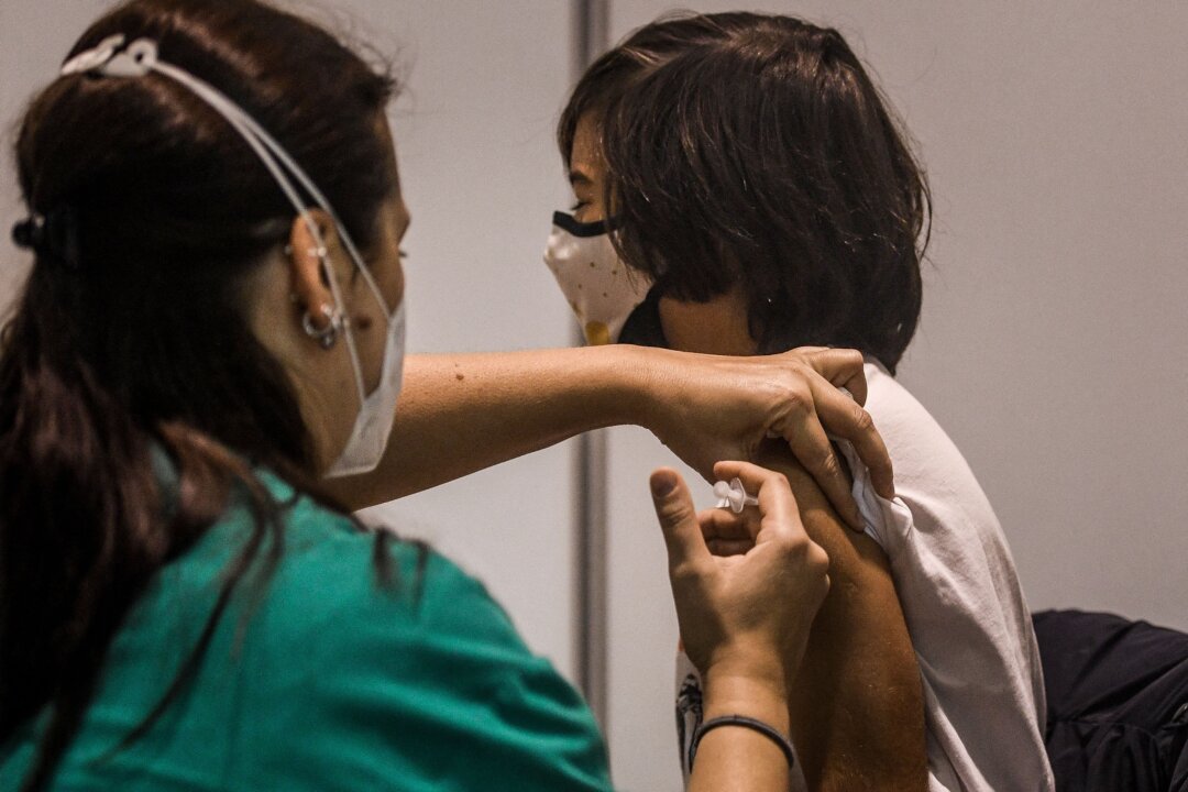 A child receives a dose of a COVID-19 vaccine in Lisbon, Portugal, on Dec. 18, 2021. (Patricia de Melo Moreira/AFP via Getty Images)