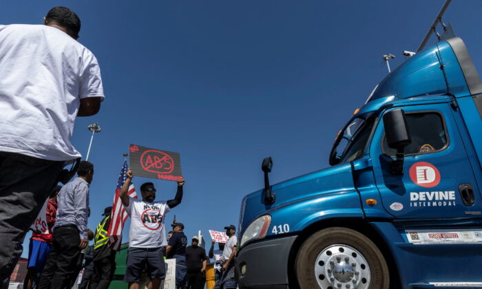 Independent truck drivers gather to delay the entry of trucks at a container terminal at the Port of Oakland, during a protest against California's law known as AB 5, in Oakland, Calif., on July 18, 2022. (Carlos Barria/Reuters)