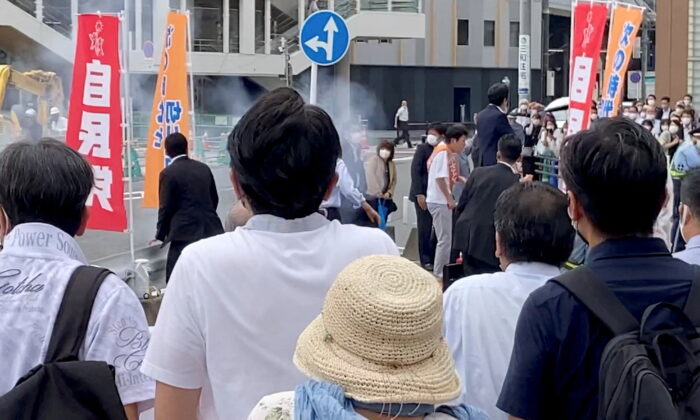 The first moment when a gunfire is shot while former Japanese prime minister Shinzo Abe speaks during an election campaign in Nara, Japan, on July 8, 2022, in this still image obtained from a social media video. (Takenobu Nakajima/via Reuters)