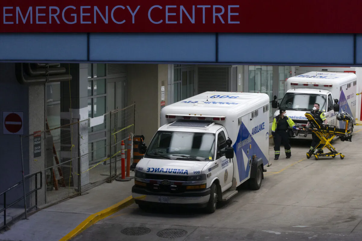 Paramedics push a gurney toward an ambulance outside a Toronto Hospital on Jan. 5, 2022. (The Canadian Press/Chris Young)