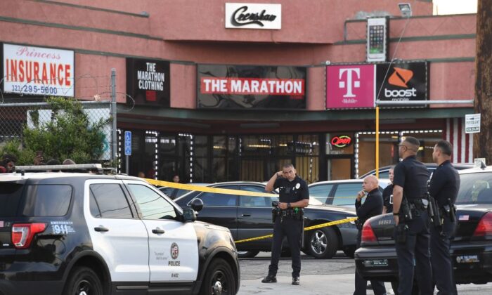 Police outside The Marathon clothing store owned by Grammy-nominated rapper Nipsey Hussle where he was fatally shot along with 2 other wounded, in Los Angeles on March 31, 2019. (Mark Ralston/AFP via Getty Images)