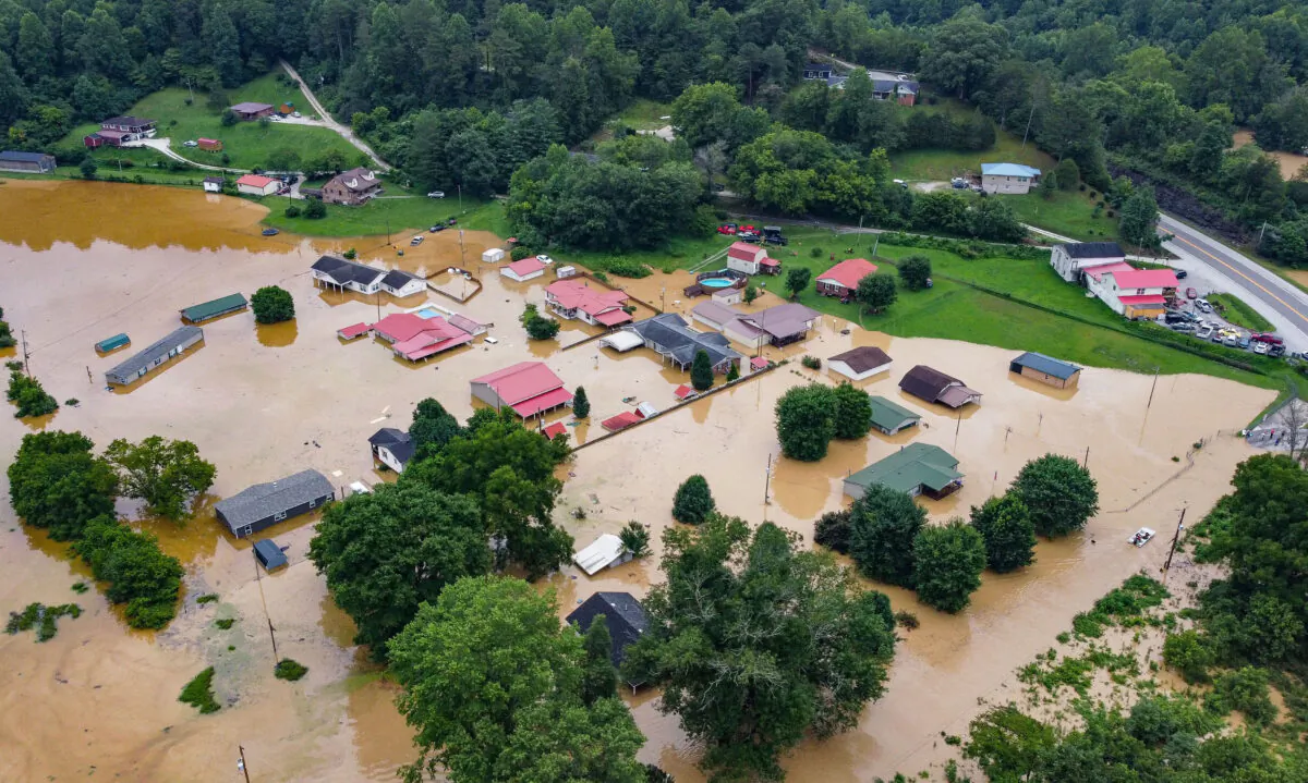 Aerial view of homes submerged under flood waters from the North Fork of the Kentucky River in Jackson, Ky., on July 28, 2022. (Leandro Lozada/AFP via Getty Images)
