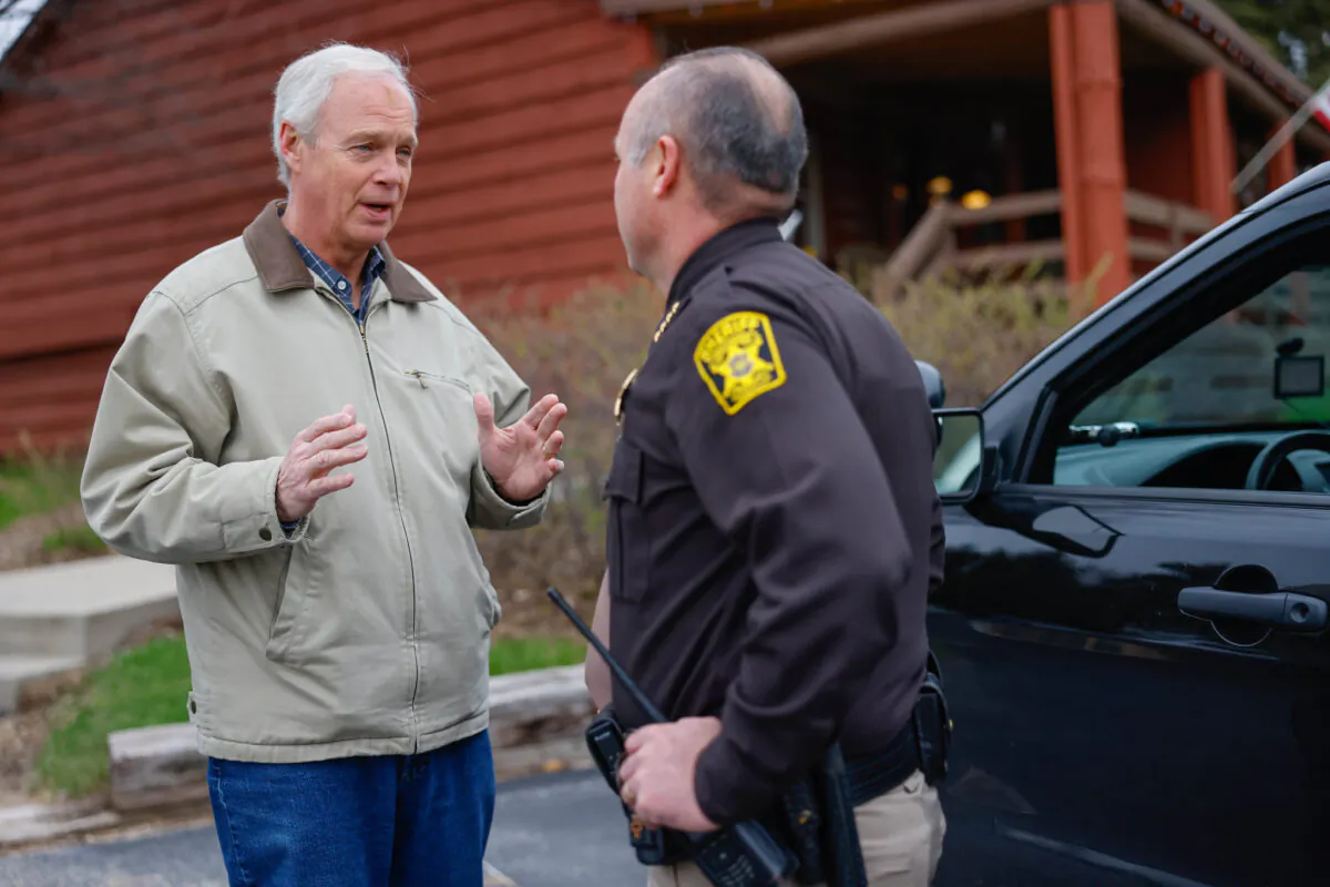 U.S. Sen. Ron Johnson (R-Wis.) speaks with a law enforcement officer in an undated photo. (Courtesy of Ron Johnson for Senate)
