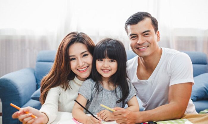 A concept family photo of a happy husband, wife, and daughter. (Fotolia)