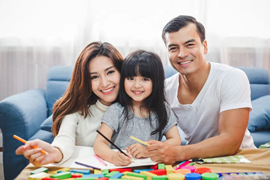 A concept family photo of a happy husband, wife, and daughter. (Fotolia)