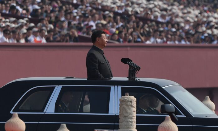 Chinese leader Xi Jinping begins a review of troops from a car during a military parade at Tiananmen Square in Beijing on Oct. 1, 2019. (Greg Baker/AFP via Getty Images)