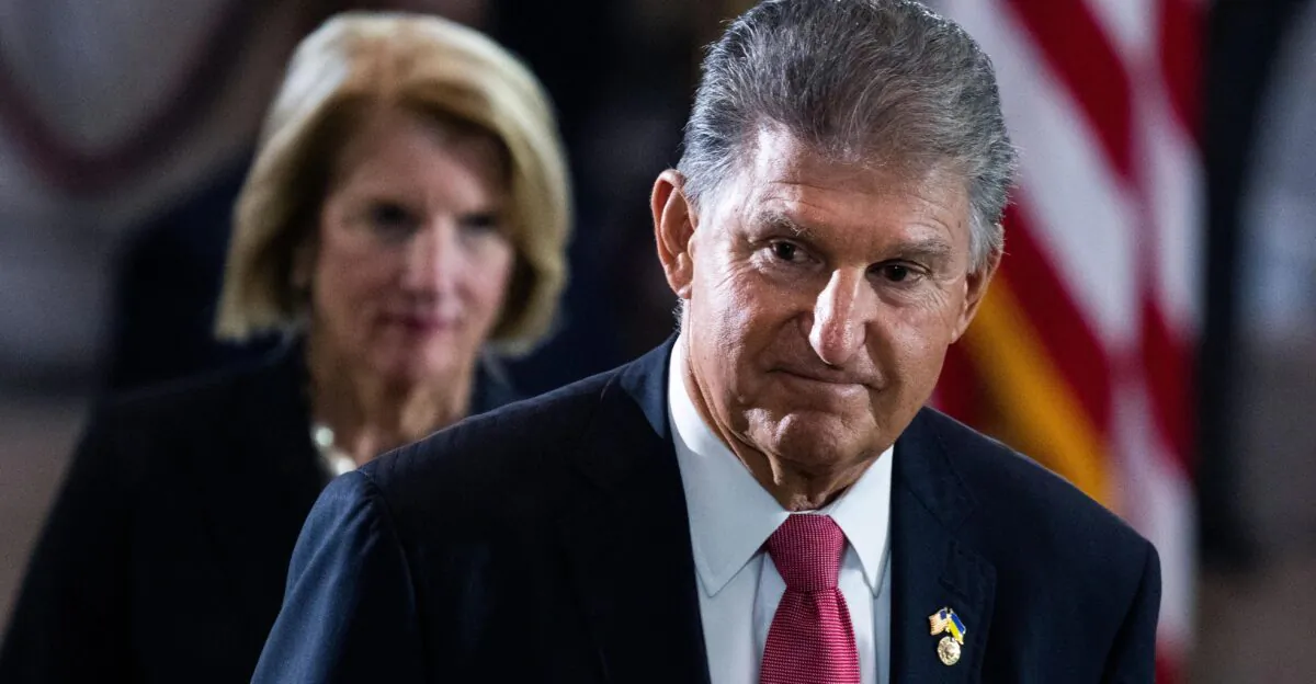 Sen. Joe Manchin (D-W. Va.) pictured paying respects to World War II veteran and Medal of Honor recipient Hershel “Woody” Williams in the Capitol Rotunda on July 14, 2022. (Tom Williams/Pool/Getty Images)