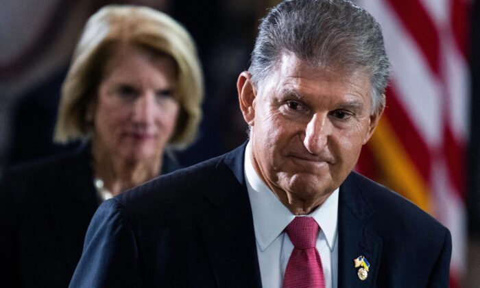 Sen. Joe Manchin (D-W. Va.), pictured paying respects to World War II veteran and Medal of Honor recipient Hershel “Woody” Williams in the Capitol Rotunda on July 14, 2022. (Tom Williams/Pool/Getty Images)