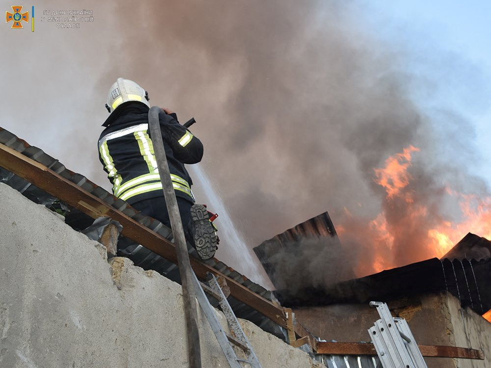 A firefighter works to douse a fire