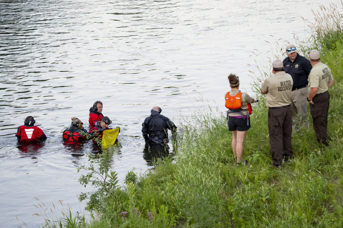 Water Recovery authorities comb the Apple River with metal detectors after five people were stabbed while tubing down the river in Somerset, Wis., on July 30, 2022. (Alex Kormann/Star Tribune via AP)