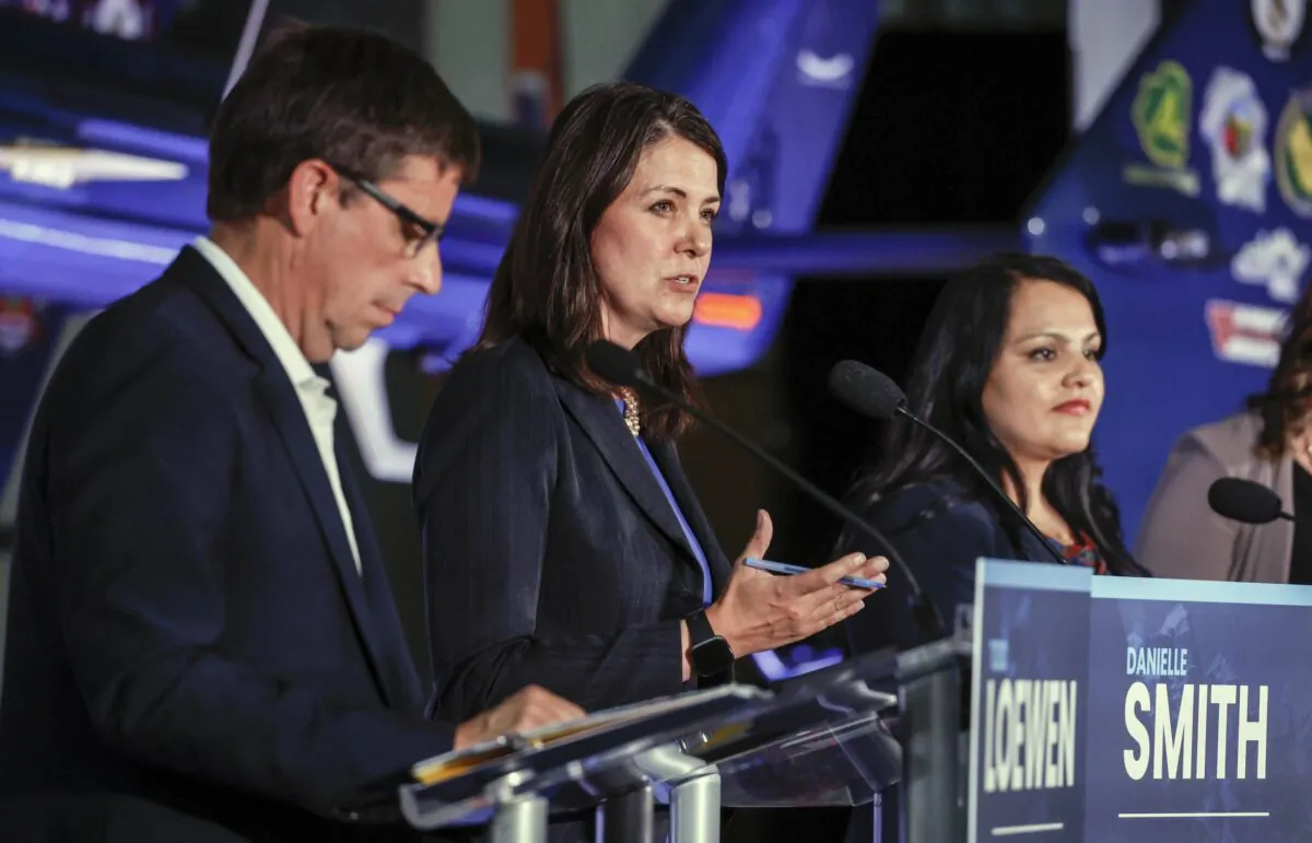 Danielle Smith (C) makes a comment as Todd Loewen (L) and Rajan Sawhney listen during the United Conservative Party of Alberta leadership candidates' debate in Medicine Hat, Alta., on July 27, 2022. (Jeff McIntosh/The Canadian Press)