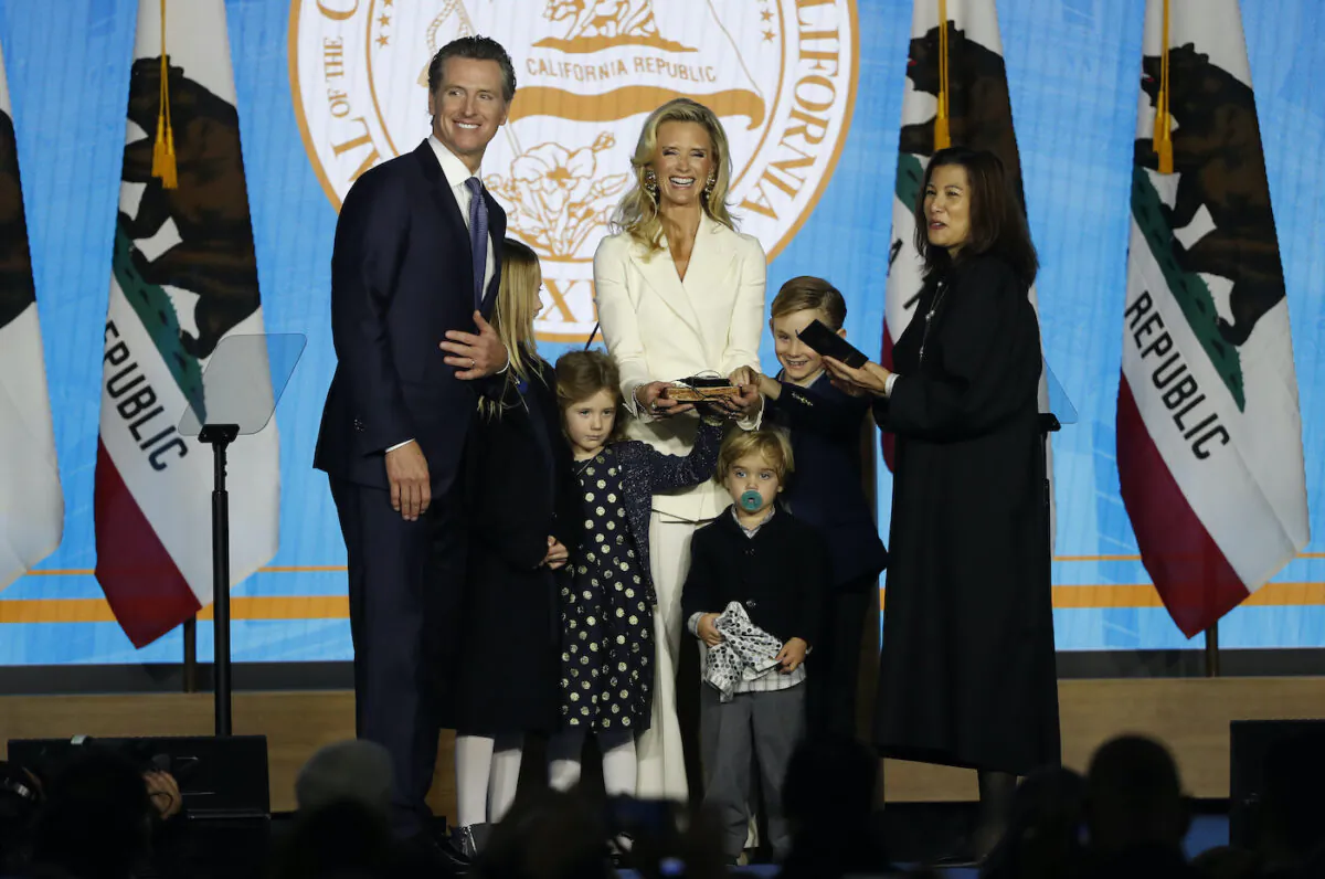 Gavin Newsom (L) is sworn in as governor of California by California Chief Justice Tani Gorre Cantil-Sakauye (R) as Newsom's family watches in Sacramento on Jan. 7, 2019. (Stephen Lam/Getty Images)