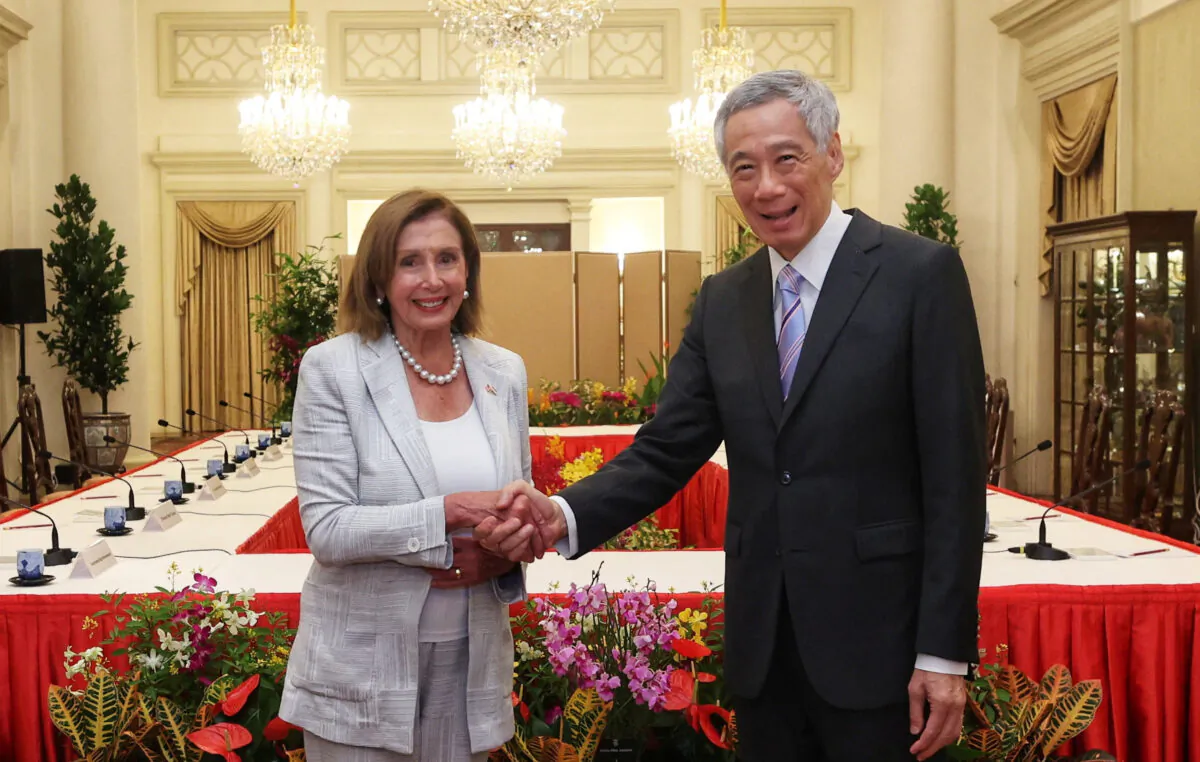 U.S. House Speaker Nancy Pelosi (L) shakes hands with Singapore's Prime Minister Lee Hsien Loong in Singapore on Aug. 1, 2022. (Mohd Fyrol Official Photographer/Ministry of Communications and Information/Handout via Reuters)