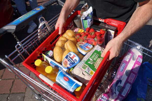 Shoppers load groceries into car
