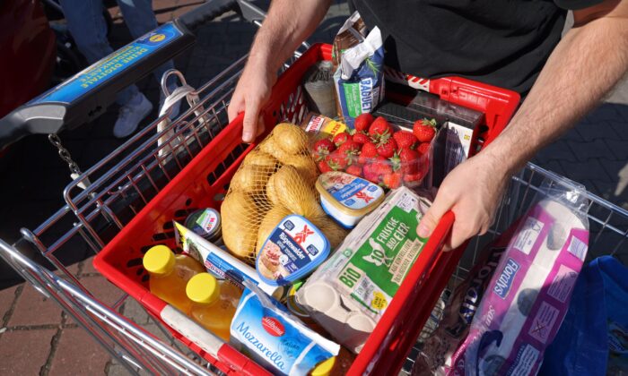 A shopper prepares to load groceries into his car outside a discount supermarket in Berlin, Germany, on June 15, 2022. (Sean Gallup/Getty Images)