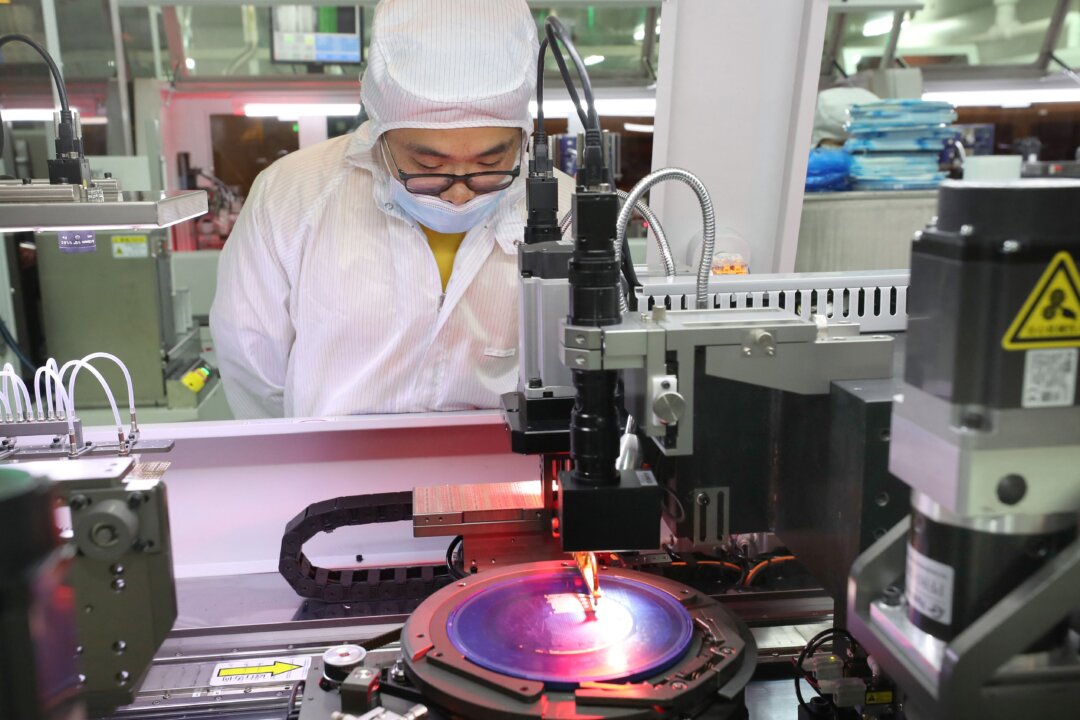 An employee makes a chip at a factory of Jiejie Semiconductor Company in Nantong, in eastern China's Jiangsu Province, on March 17, 2021. (STR/AFP via Getty Images)
