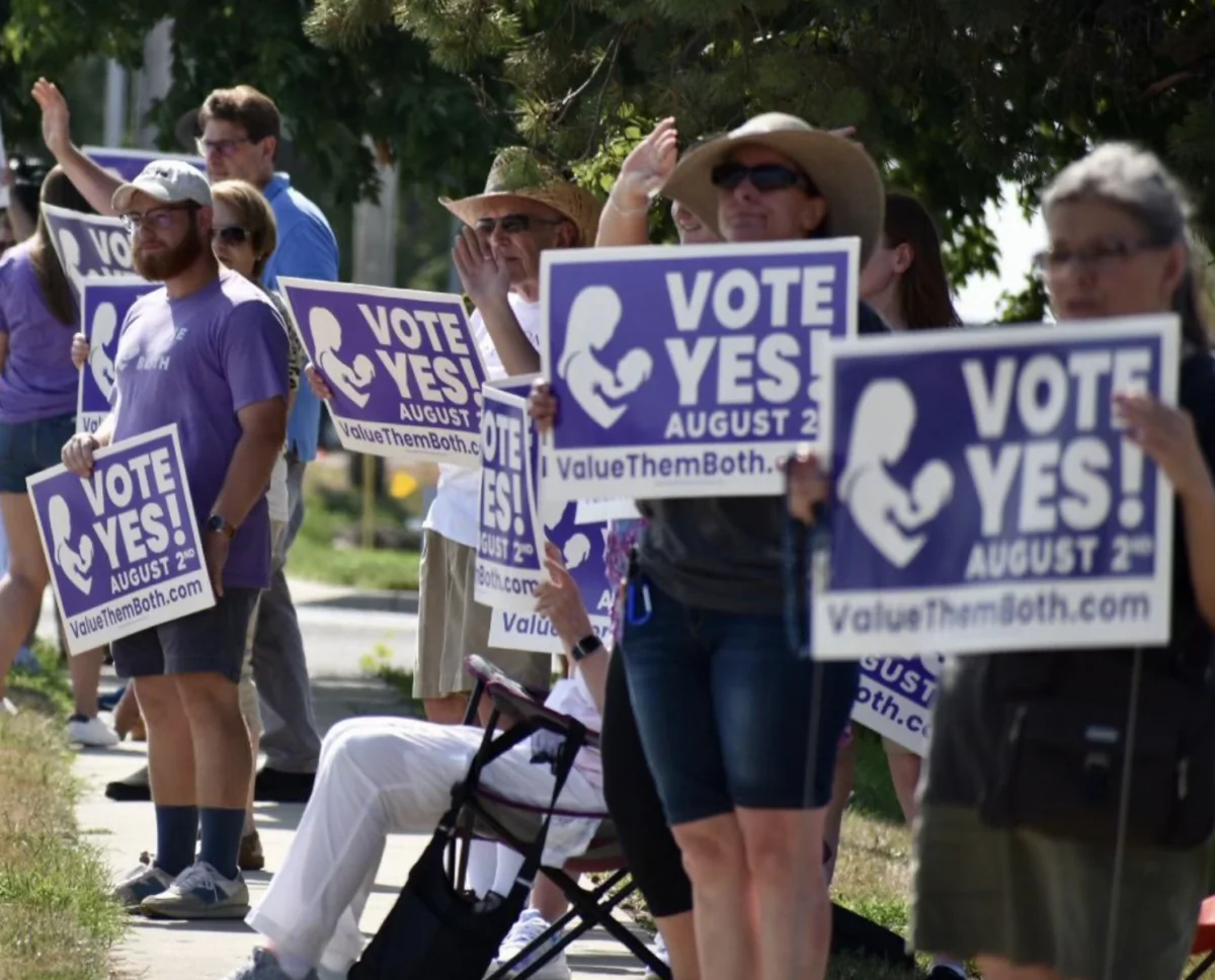 ‘Value Them Both’ amendment supporters line a sidewalk near a polling site in Olathe, Kansas, during the state’s Aug. 2 special election – the nation’s first public referendum on abortion since the U.S. Supreme Court in June overturned Roe vs. Wade, kicking regulation back to states. (Courtesy of the Value Them Both coalition)