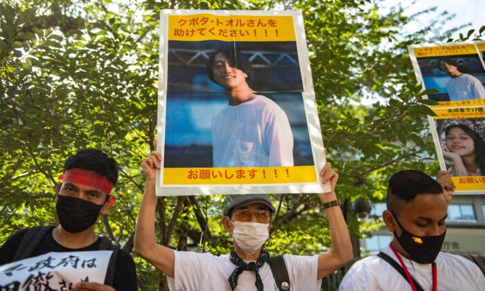 A group of activists hold placards of Japanese citizen Toru Kubota, who is detained in Burma, during a rally in front of the Ministry of Foreign Affairs in Tokyo, Japan, on July 31, 2022. (PHILIP FONG/AFP via Getty Images)