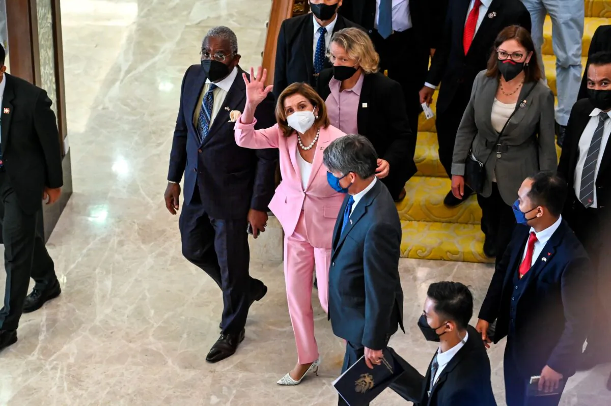 U.S. House Speaker Nancy Pelosi (C) waves to media as she tours the parliament house in Kuala Lumpur, Malaysia, on Aug. 2, 2022. (Malaysia’s Department of Information via AP)
