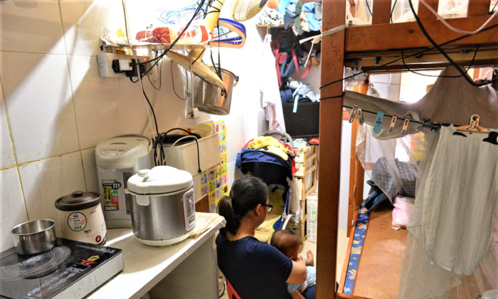 A woman and a child in a subdivided unit in Hong Kong on Aug. 3, 2022. (Sung Pi-lung / The Epoch Times)
