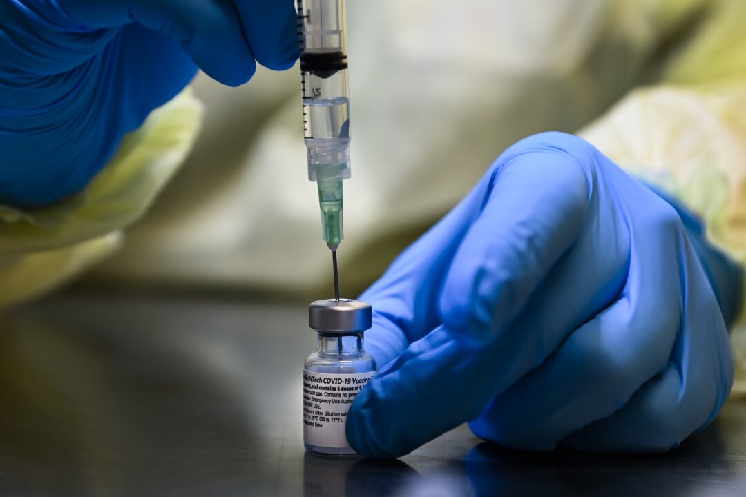 A health care worker prepares a dose of the Pfizer-BioNTech COVID-19 vaccine at a UHN COVID-19 vaccine clinic in Toronto on Jan. 7, 2021. (Nathan Denette/The Canadian Press)