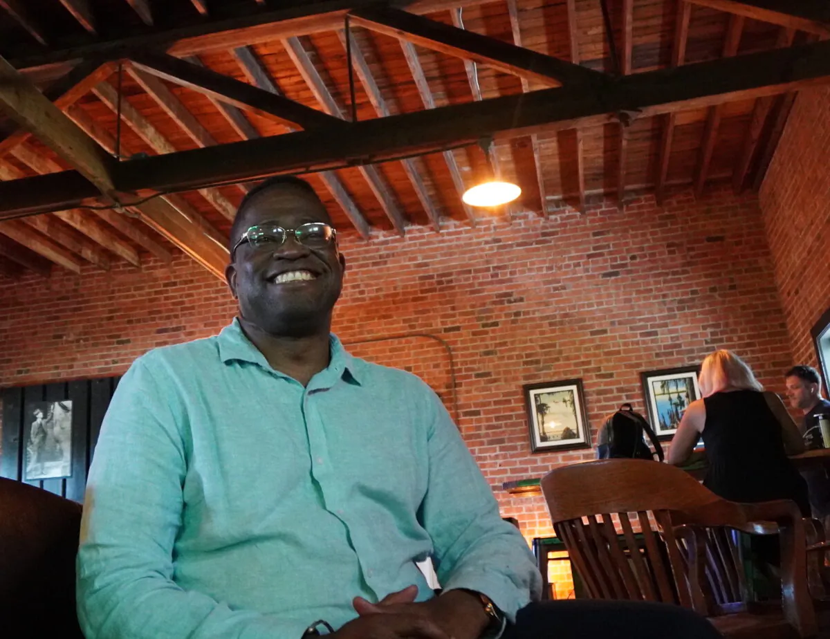 Jaha Cummings takes time out of his day at a Punta Gorda, Fla., coffee shop and speak to his constituents about issues important to them as he campaigns for a county commission seat on Aug. 1, 2022. (Jann Falkenstern/The Epoch Times)