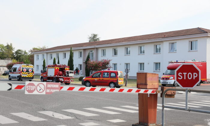Firefighter vehicles at an entrance of the Manuco factory, which produces a compound used in gunpowder, after a blast occurred, injuring eight people, one of them seriously, in Bergerac, southern France, on Aug. 3, 2022. (Yohan Bonnet/AFP via Getty Images)
