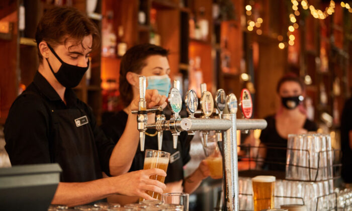 Staff pouring drinks at a hotel in Perth, Australia, on Feb. 5, 2021. (Stefan Gosatti/Getty Images)