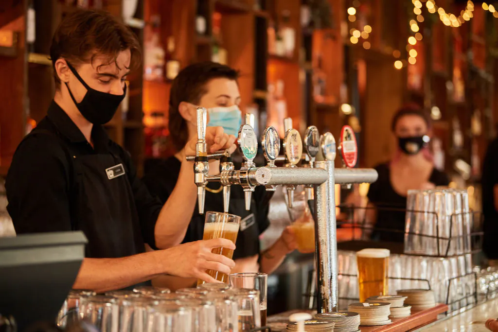Staff pouring drinks at a hotel in Perth, Australia, on Feb. 5, 2021. (Stefan Gosatti/Getty Images)